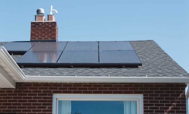 brown brick house with solar panels on roof