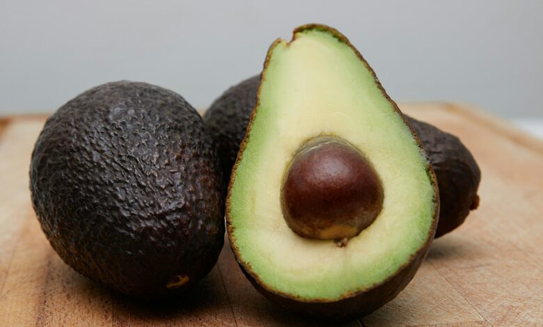 sliced avocado fruit on brown wooden table